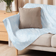 Soft sherpa blankets draped over a couch, inviting cozy relaxation