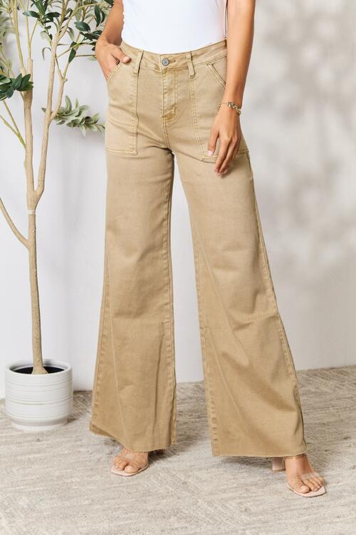An image showcasing a petite woman wearing wide leg jeans, emphasizing their flattering silhouette and tailored fit