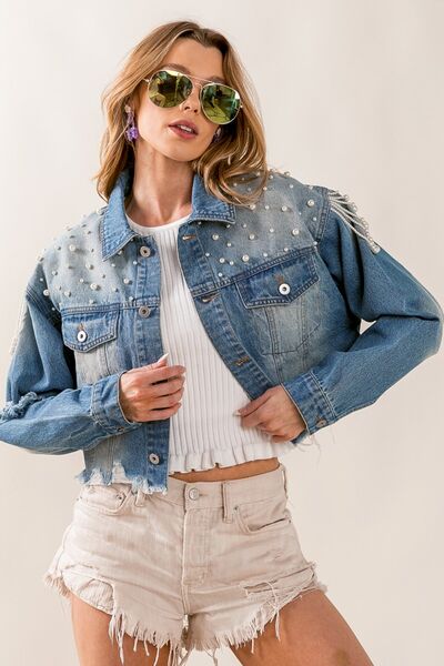 A collection of white denim jackets displayed on mannequins or hangers, showcasing various styles and fits, embodying versatile fashion for a range of occasions.