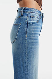 An image showcasing a woman wearing low rise bootcut jeans, exuding modern classic style and sophistication